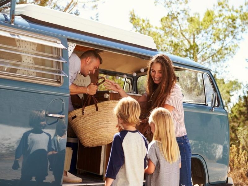 family with young kids preparing for road trip